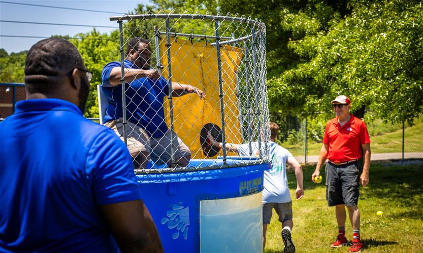 A student presses the button of a dunk tank